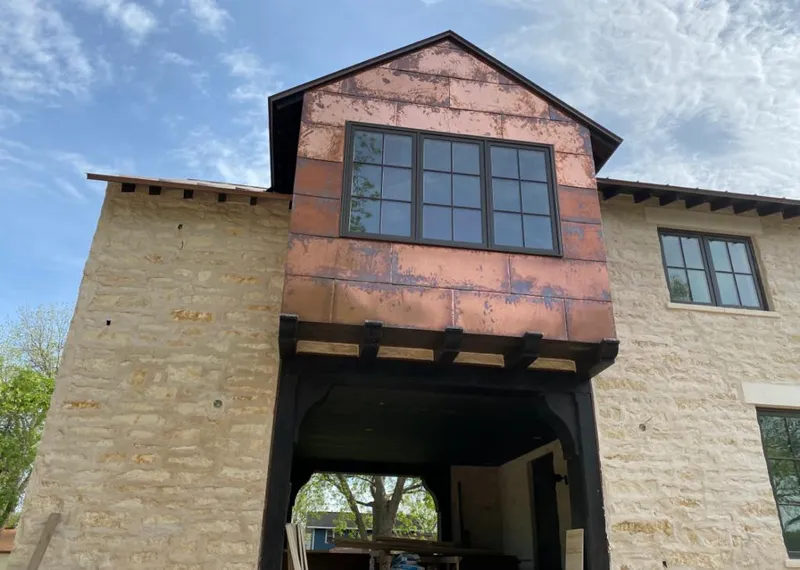 Copper metal panel facade on a stone building for Roof Repair in Pearl City