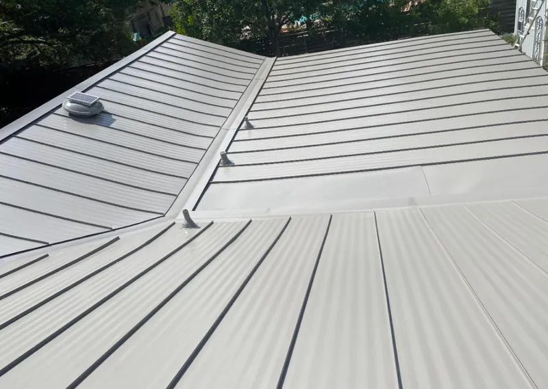 Solar attic fan installed on a metal roof for Roof Ventilation in Pearl City